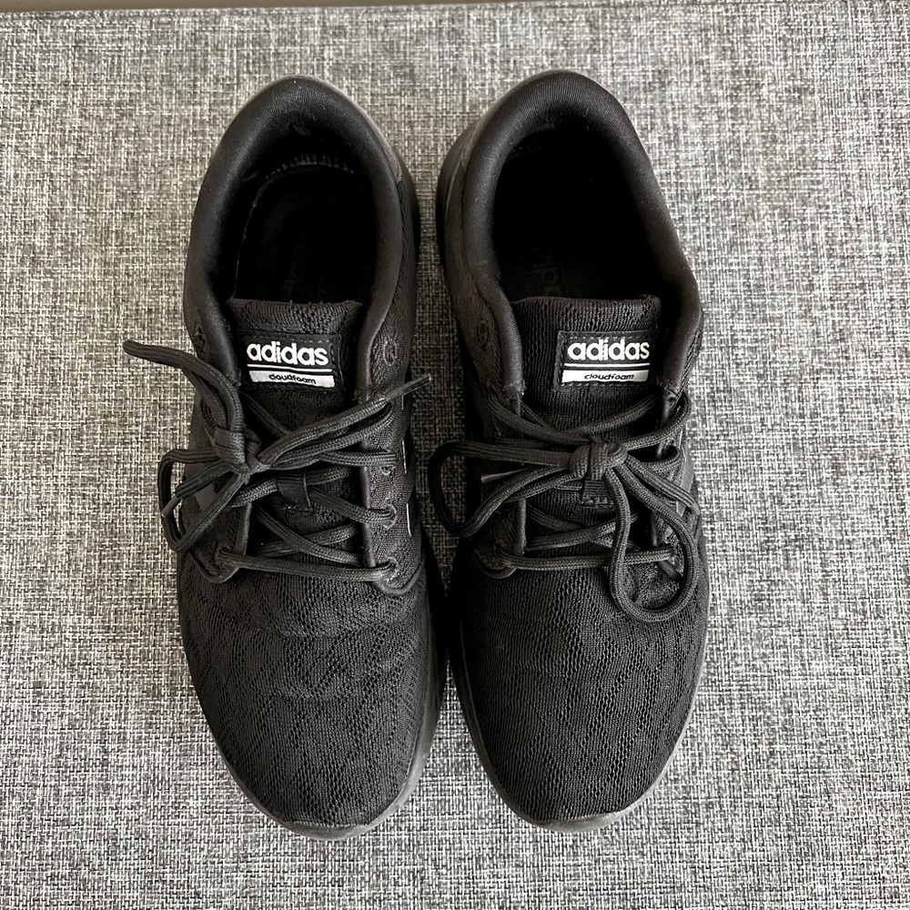 All black Adidas cloudform sneakers.